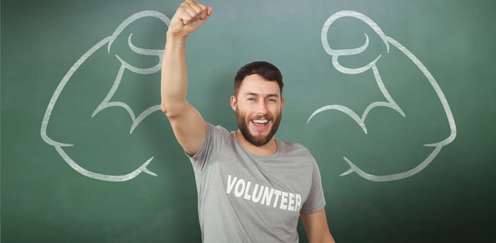 Portrait of cheerful volunteer  against green chalkboard
