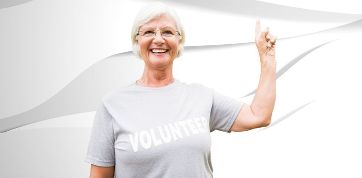 Happy volunteer grandmother with thumbs up  against white wave design