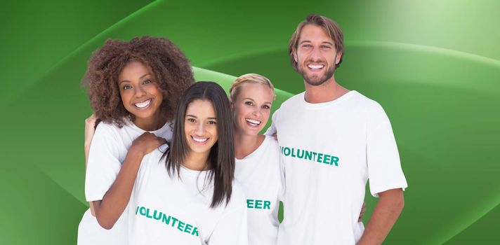 Smiling group of volunteers against abstract green design