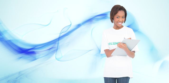 Smiling volunteer woman holding clip board against blue abstract design