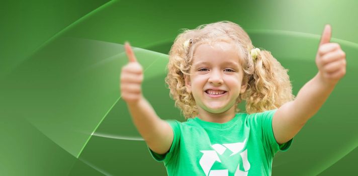 Happy little girl in green with thumbs up  against abstract green design