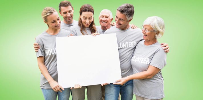 Happy volunteer family holding a blank  against green vignette