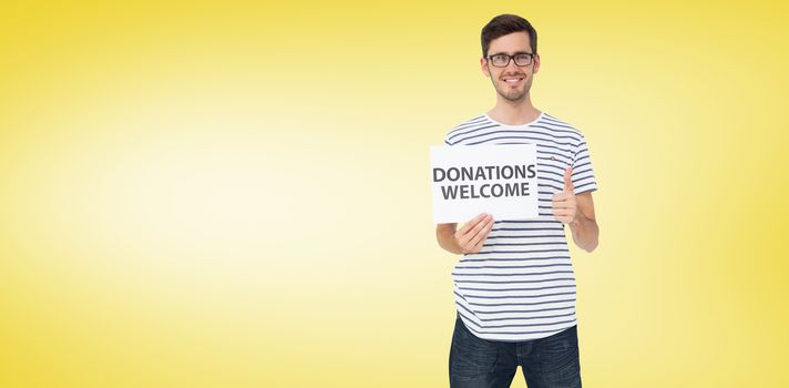 Man holding a donation welcome note while gesturing thumbs up against yellow vignette