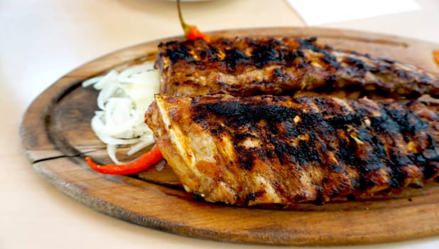 spare ribs in wooden plate with vegetables