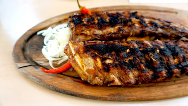 spare ribs in wooden tray with vegetables