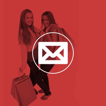 Two beautiful young women with shopping bags the thumbup against envelope