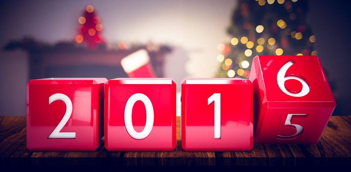 2016 in red blocks against christmas tree with presents near the fireplace