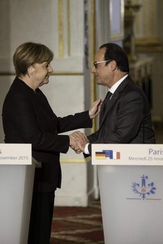 FRANCE, Paris: German Chancellor Angela Merkel and French President Francois Hollande shake hands during a press conference at the Elysee Presidential Palace, in Paris, on November 25, 2015. Mr Hollande is seeking to establish a 'grand and single coalition' to fight the Islamic State group, also known as Daesh or ISIS, in the aftermaths of the November-13 Paris terror attacks.