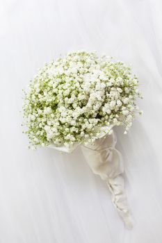 Wedding bouquet on a white vail.