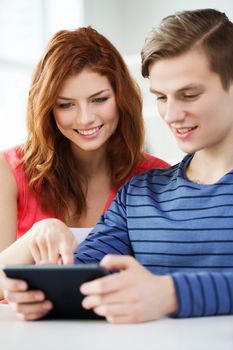 education, technology and internet concept - smiling students with tablet pc computers at school