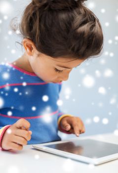 education, winter, technology and people concept - little girl with tablet pc at home