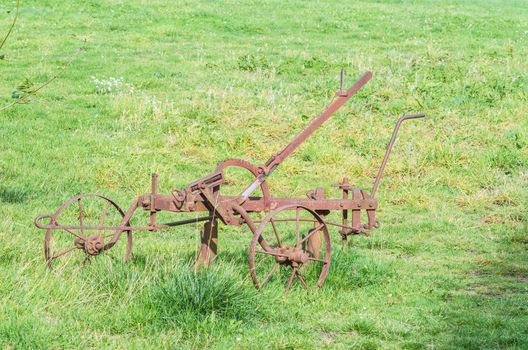 Old historical rusty plow on a farm in Germany.
