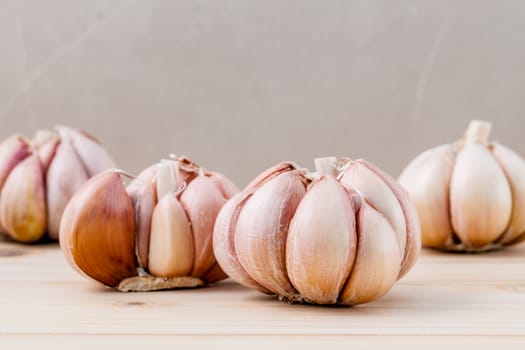 Close Up organic garlic with selective focus on the teak wood background