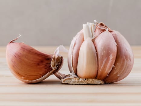 Close Up organic garlic with selective focus on the teak wood background