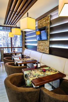 Modern restaurant interior with tables and sofas