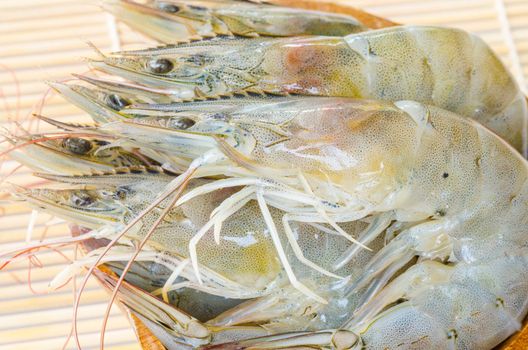 Top view of Fresh Gulf Shrimps in cup on wooden background.