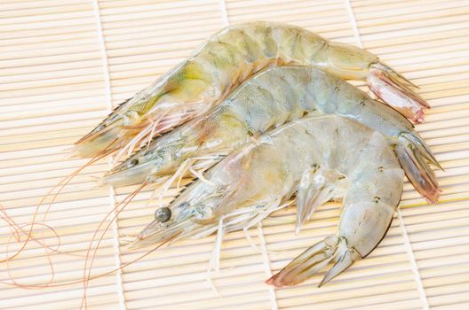 Top view of Fresh Shrimps on wooden mat background.