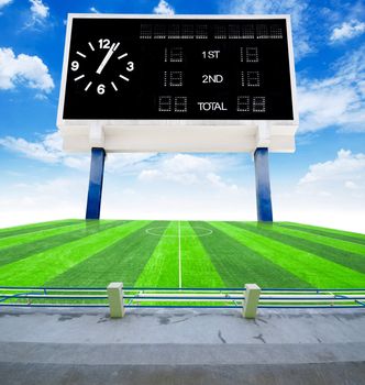 Old black score board in field soccer with blue sky view from stadium.