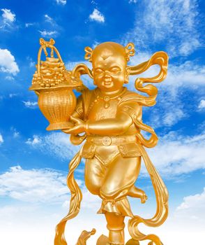 Gold God of Wealth or prosperity (Cai Shen) statue on blue sky background.