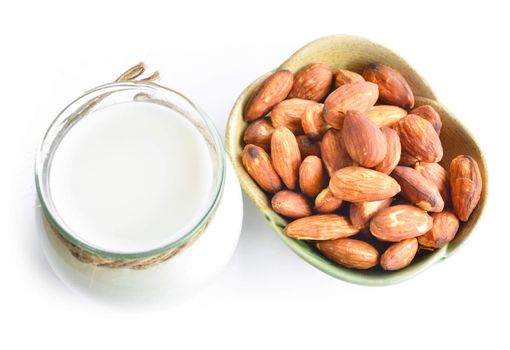 Almond milk and almond on white background.