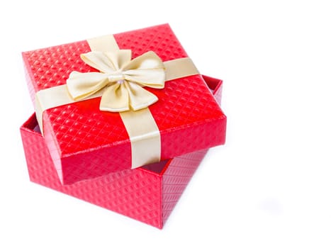 Single red gift box with glod ribbon on white background.