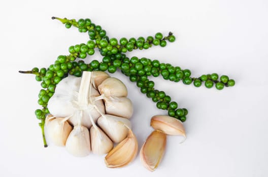 fresh garlic and fresh green peppers on white background.