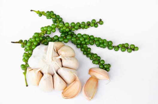 Garlic and fresh green pepper on white background.