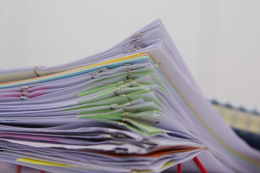 Pile of documents and blur notebook in basket at office.