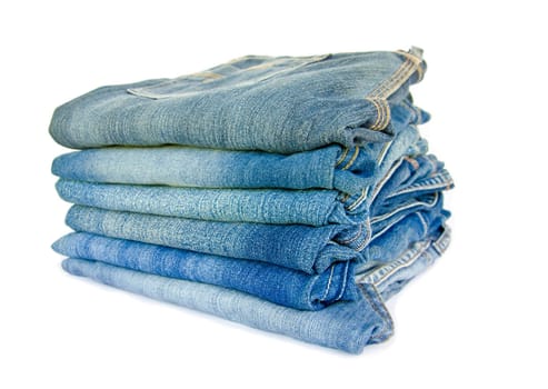 Lot of different blue jeans isolated on white background.