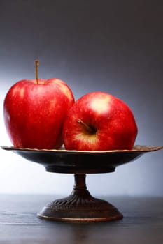 Two red apples in nice metal vintage fruit bowl