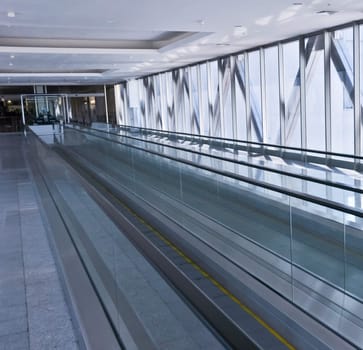 the empty escalator inside the contemporary building