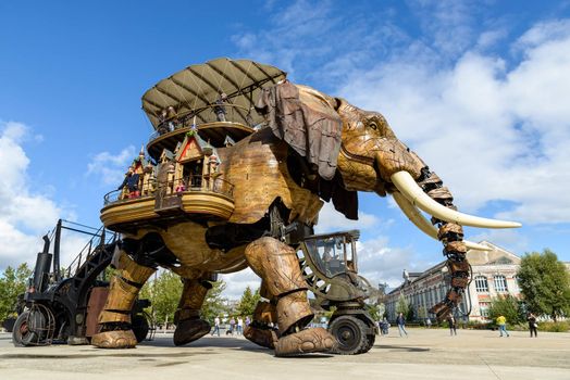 NANTES, FRANCE - CIRCA SEPTEMBER 2015: The Great Elephant goes for a walk with passengers aboard.