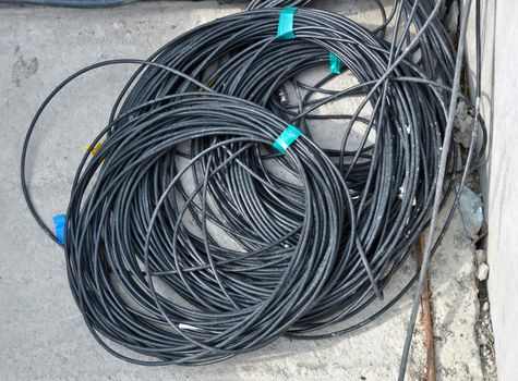 the coil of black electrical cable