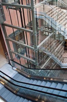 Glass lift shafts and escalators in a modern office building