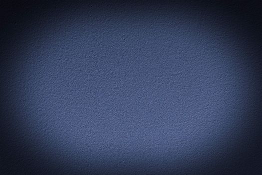 Navy blue wall with vignette, a background or texture
