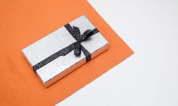 silver gift box with bow on white background