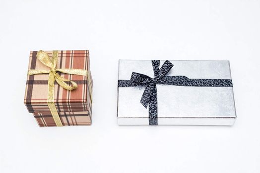 brown and silver gift box with bow on white background