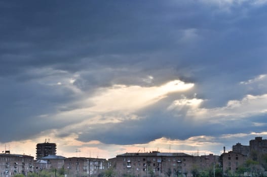 landscape with a cloudy sky and old residential buildings