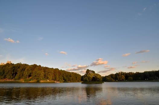 landscape with a lake and forest at sunset