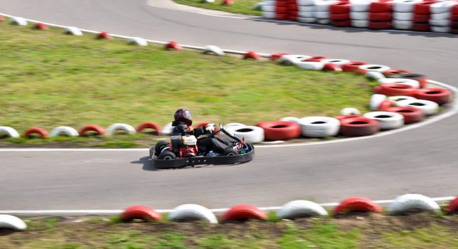 go kart racing on circuit blurry