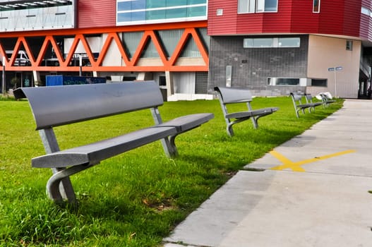 Modern bench in a green grassy lawn