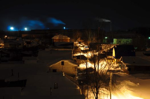 Night Village with smoking chimneys on the horizon