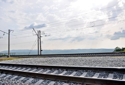 railroad track, embankment, and power poles