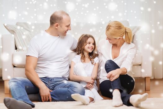 family, childhood, communication, people and home concept - smiling parents with little girl sitting on floor at home