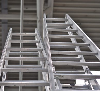 close-up of two metal ladders on a dark background