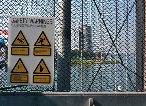 Danger warning signs hanging on a metal grid