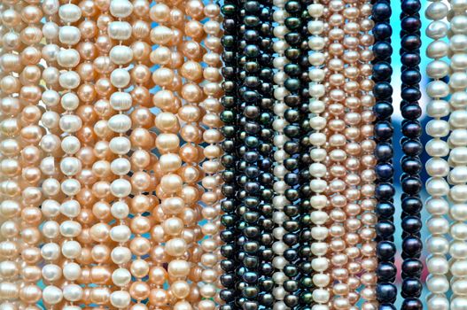 a lot of pearl beads hanging in a row
