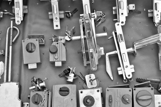 many Old door locks on open-air bazaar BW