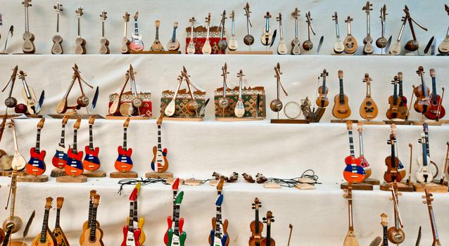 People craft miniature musical instruments made of wood