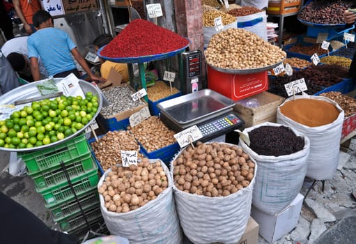 spices and nuts on the scales and dishes in an old bazaar in Tehran, Iran